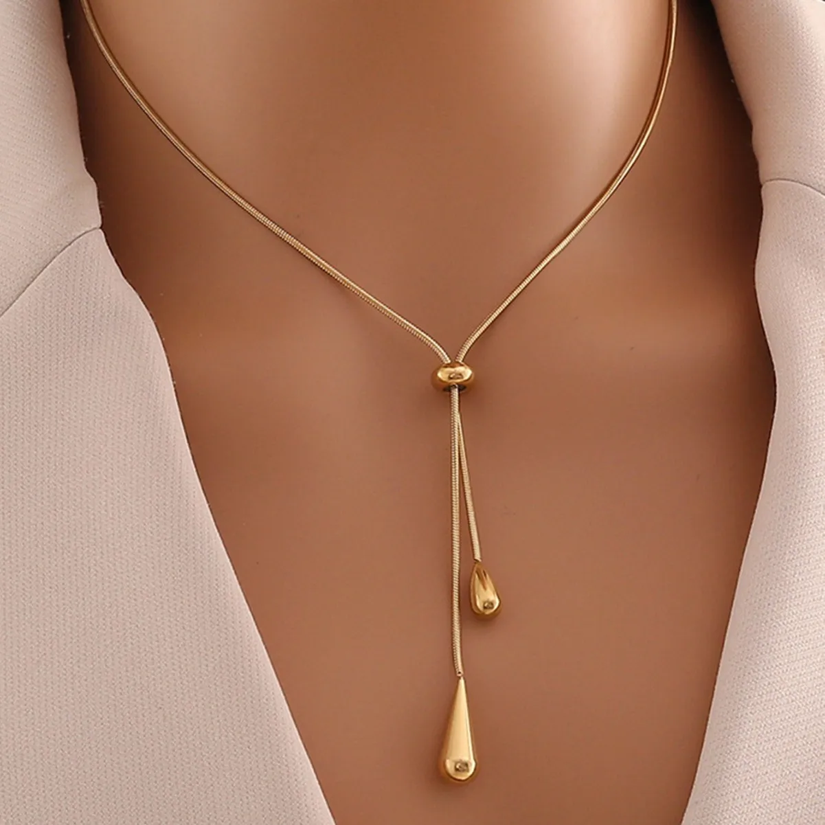 Gold teardrop tassel stainless steel necklace on model